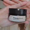 Video of a woman applying the Pamoja Reset cleansing balm to her skin and removing it with an organic cotton muslin cloth. Reset is a gentle natural moringa cleansing balm for dry skin